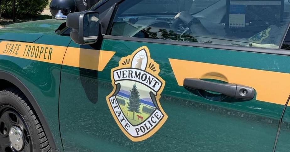 Vermont State Police emblem on a green patrol vehicle