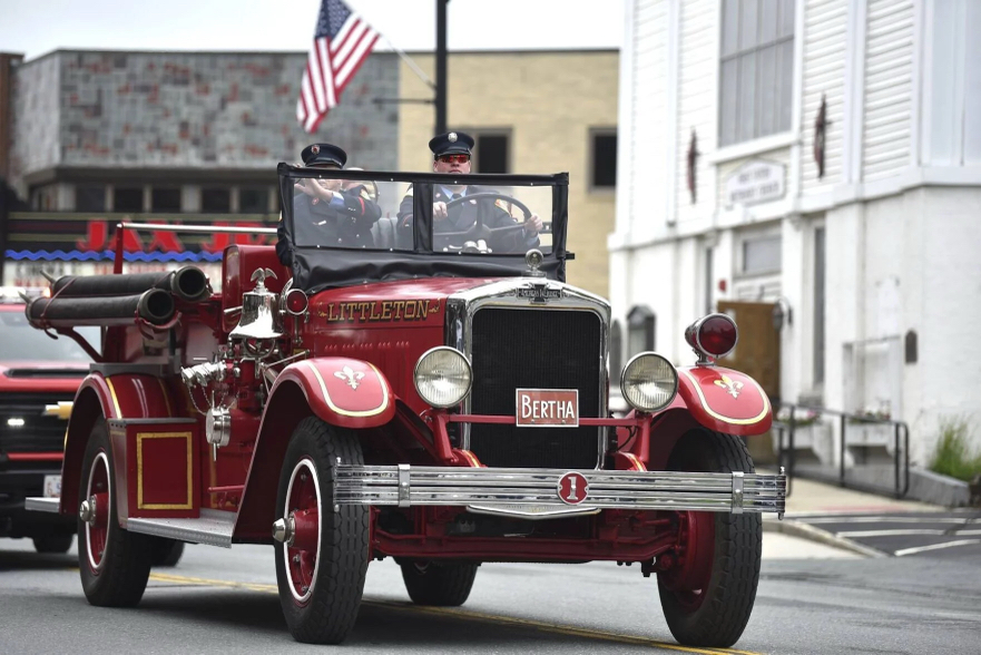 Antique red fire engine driven in a parade