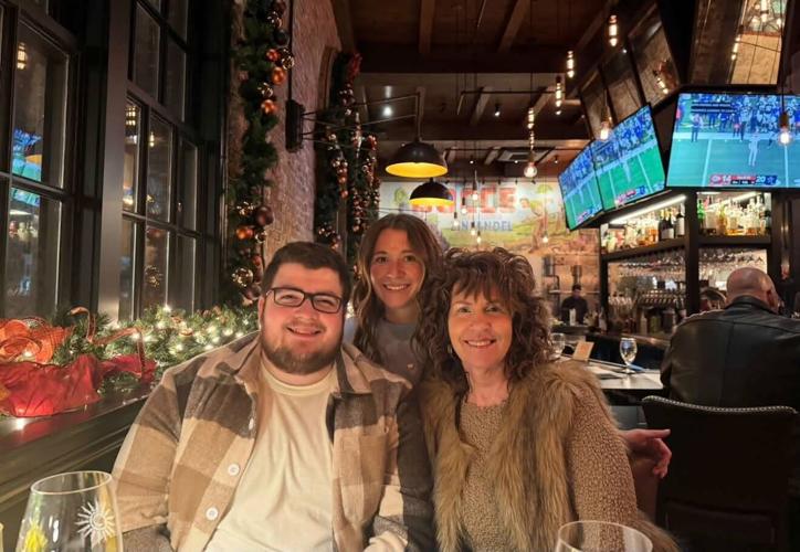 Three people seated together at a restaurant