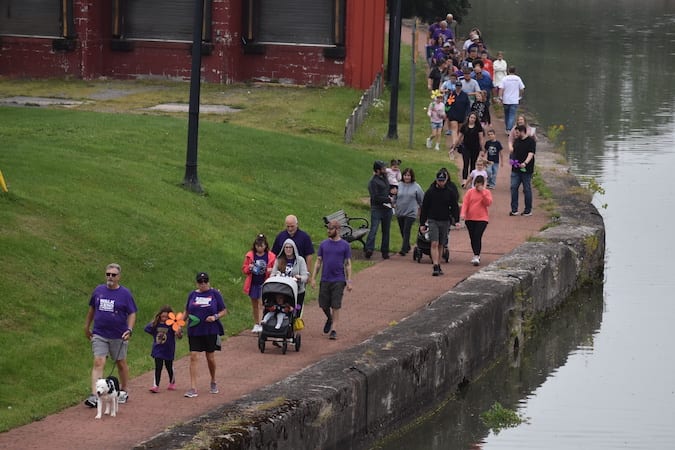 Alzheimer’s awareness walk participants following a path beside the river