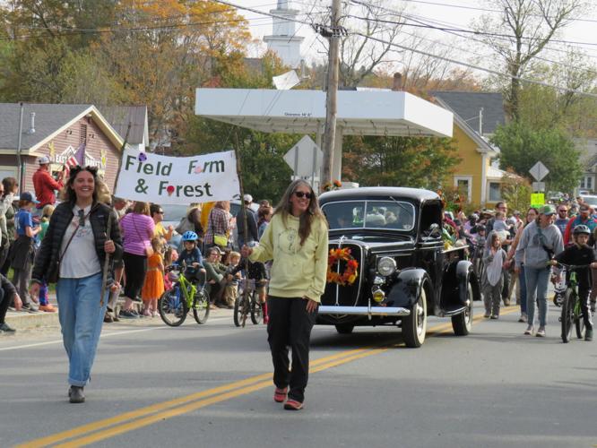 Participants carrying a Field, Farm and Forest banner in the Burke Fall Festival parade