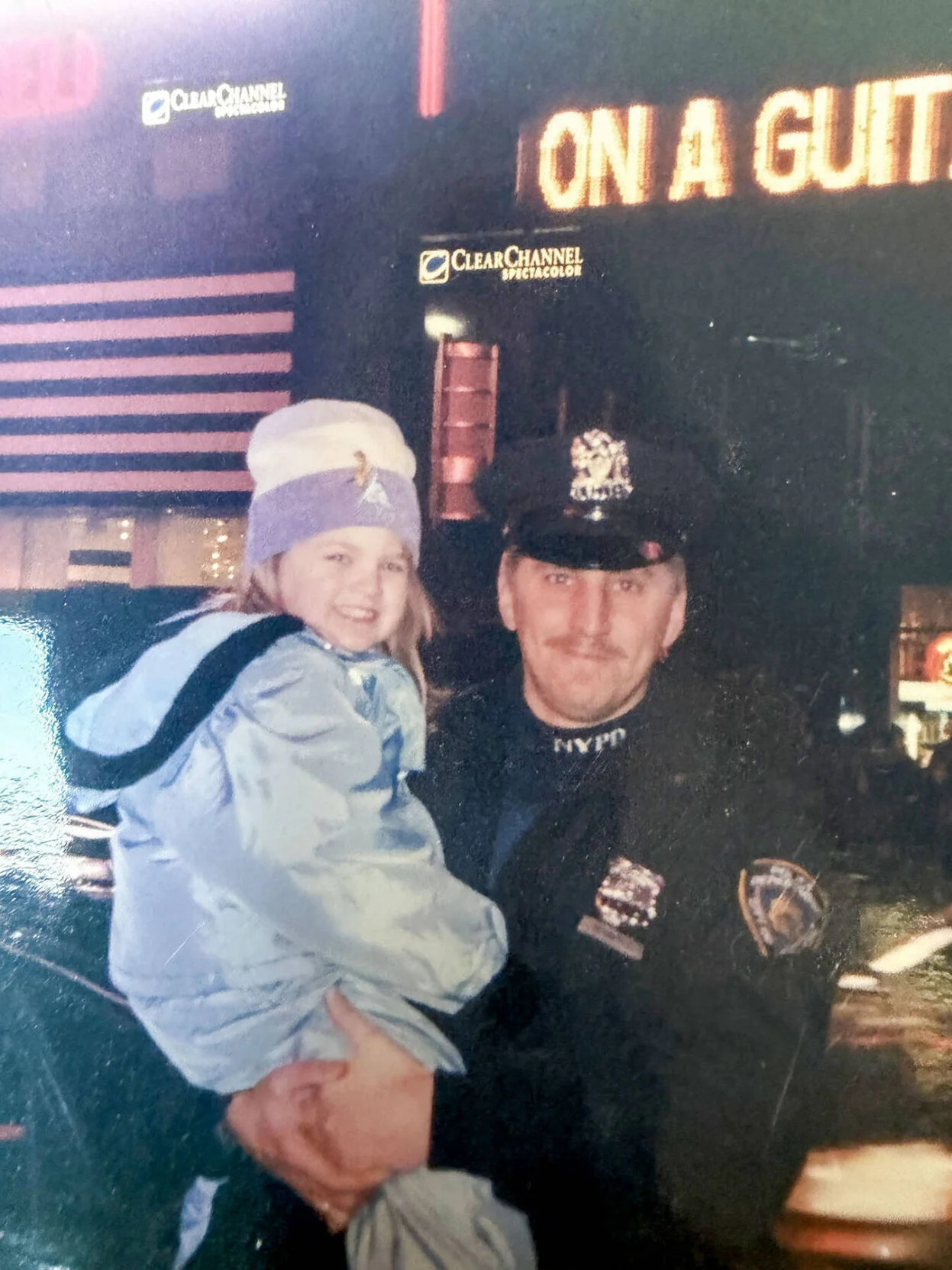 A police officer holding a young child